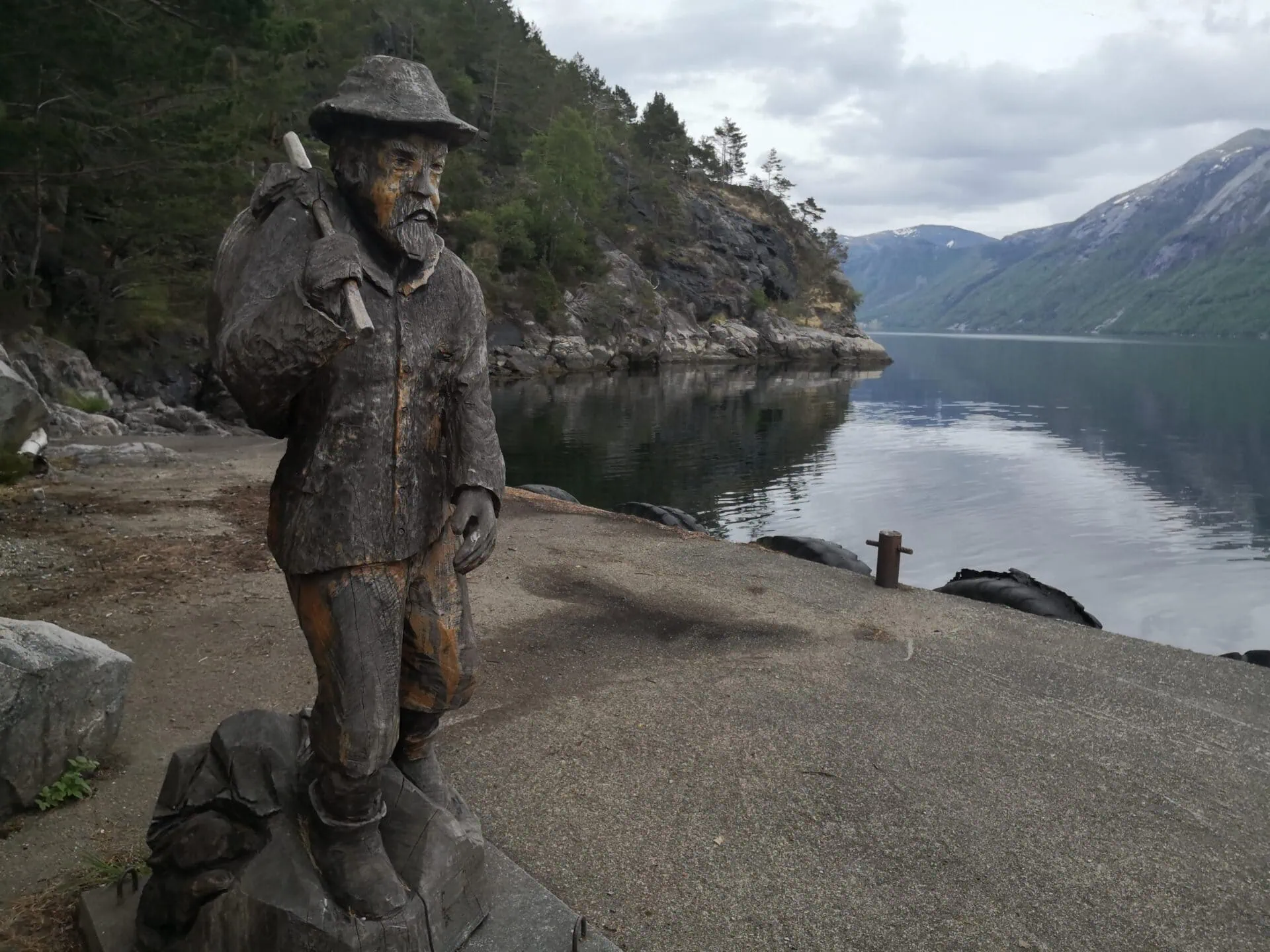Pilt-Ola Statue at Bakken Quay Wooden statue of Pilt-Ola on the quay at Bakken by the Lysefjord